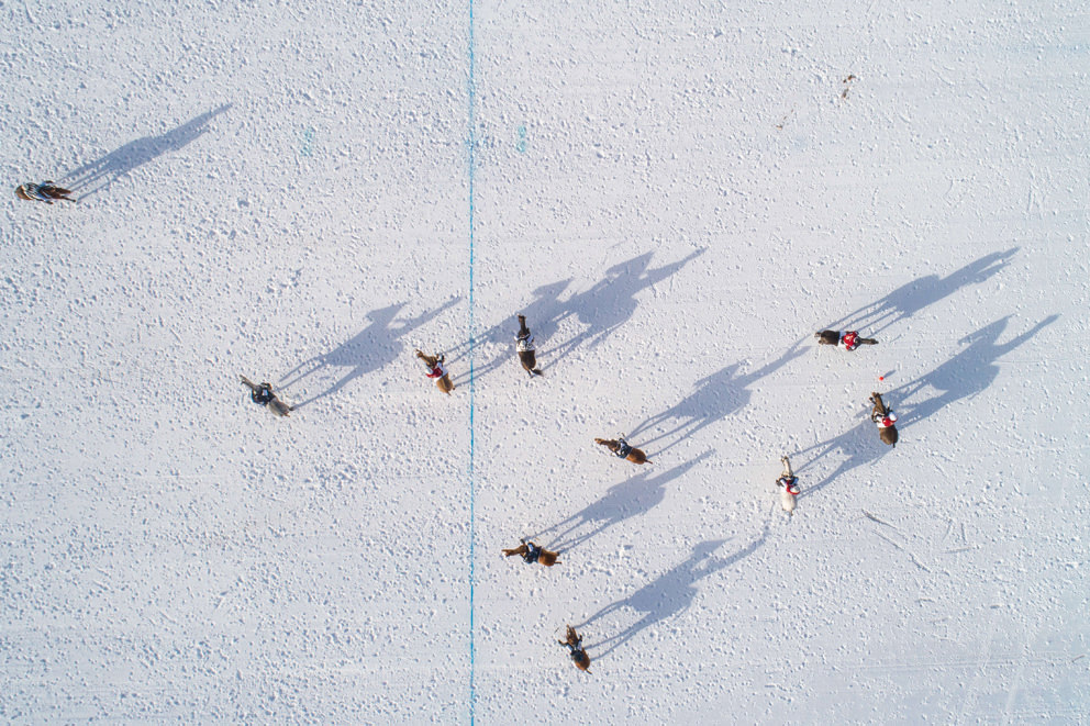 Aerial drone photo of horses and their shadows during a polo tournament in st moritz switzerland