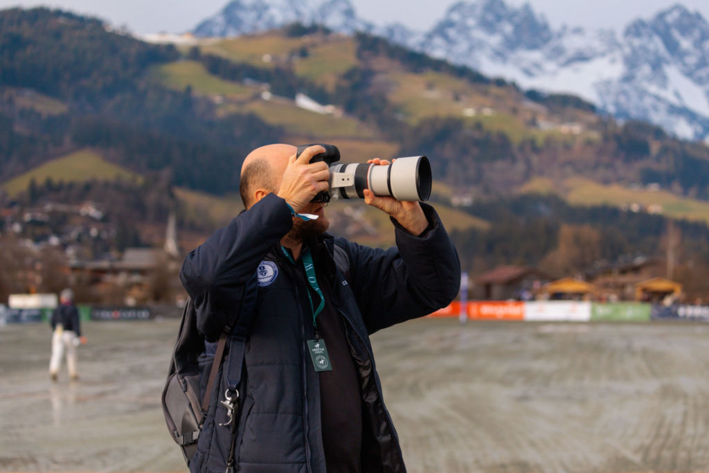 sport photographer with Canon telephoto lense using silent mirrorless Canon camera